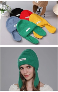 Detailed view of thick ribbed knit fabric and label on winter earflap beanie hats