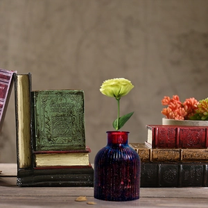 Detailed view of a vintage ribbed resin vase with deep purple and burgundy gradient finish