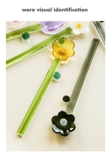Top view of colorful flower-shaped glass dessert spoons in various bright colors