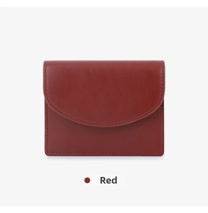 Macro view of a deep red smooth leather folding card wallet with precision stitching