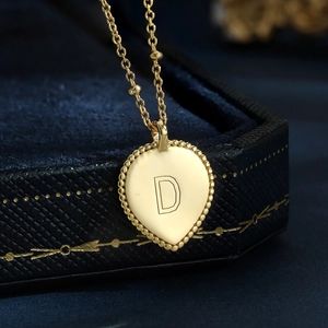 Elegant gold S925 silver heart necklace with letter D pendant on a blue velvet box