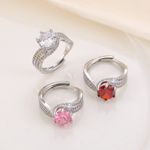 Three-row twisted rings with 3ct white, pink and red stones on beige silk fabric