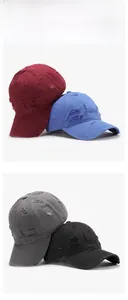 Detailed view of distressed baseball caps in burgundy, blue, grey, and black colors