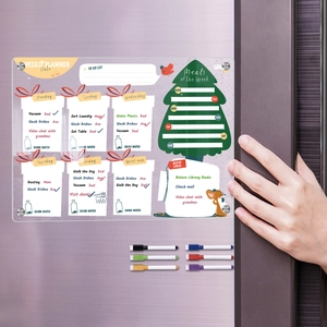 Close-up of magnetic acrylic weekly planner on fridge with colorful markers and eraser