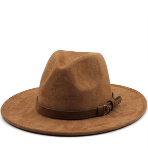 Detail of dark brown suede fedora hat with a leather buckle strap and fringe accents