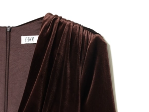 Detail of brown velvet midi dress showing ruched shoulders and back zipper texture