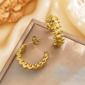 Gold vintage C-shaped stud earrings featuring stud rivets and beads in polished metal