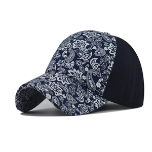 Detailed side view of navy blue paisley print baseball cap with contrast panels