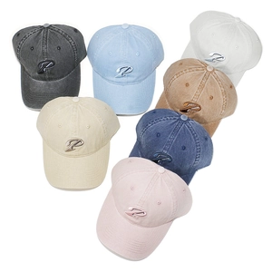 Detailed flat lay of washed cotton baseball caps in seven colors with P embroidery