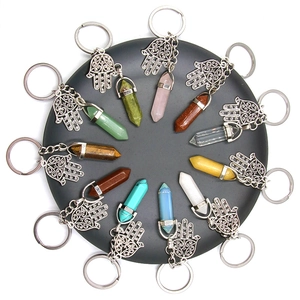 Fátima hand keychains with hexagonal crystal column pendants in assorted natural colors