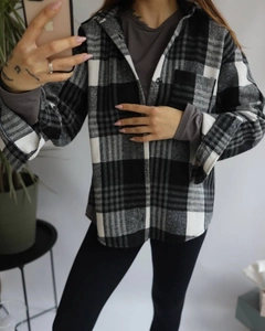 Close-up of black and white plaid wool blend shirt jacket texture and thick fabric