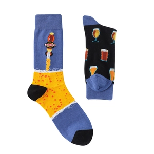 Detail of knit socks with blue and yellow beer pattern and Brew text on white background