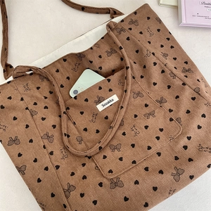 Detailed view of corduroy tote bag interior showing a smartphone in the inner pocket