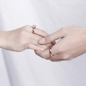 Rose gold couple rings featuring a classic solitaire engagement ring and polished band
