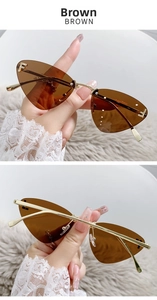 Detail of brown rimless cat-eye sunglasses featuring golden temples and crystal F accent