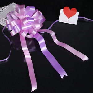 Detail of multi-layer pink and purple gradient bow with elegant hanging ribbons