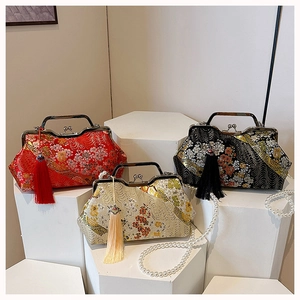 Detailed macro view of Chinese brocade shell bags with floral embroidery and pearl chains
