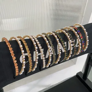 Detailed close-up of Baroque headbands with pearls and colorful crystals on gold metal frames