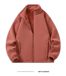 Detail of rust red fleece jacket showing warm lining and textured polar fleece fabric