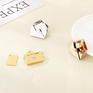 Three openable envelope pendants in silver gold and rose gold with metal inserts