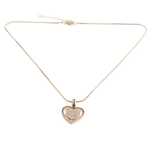 Detail of gold-plated double heart necklace with embedded crystals and lobster clasp