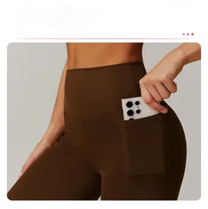 Detail of high-waisted coffee brown yoga shorts featuring functional side phone pockets
