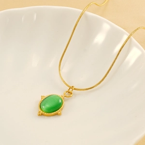 Elegant gold-plated snake chain necklace featuring an oval green gemstone in a shell dish