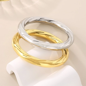 Minimalist spiral twisted 10mm stainless steel bangles in gold and silver finishes
