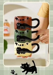 Three colorful ceramic mugs featuring black cat handles and cute 3D embossed designs