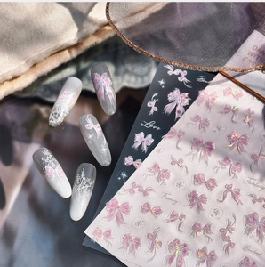 Close-up of 3D butterfly and lace nail stickers applied on clear acrylic nails