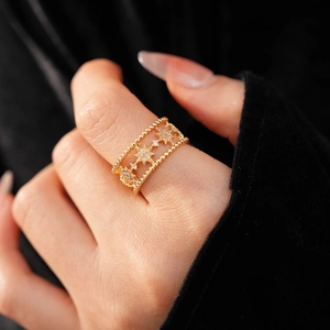 Macro view of gold-plated star ring featuring sparkling zircon stones and beaded edges