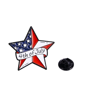 Macro detail of star shaped enamel USA flag brooch with 4th of July text and butterfly clutch