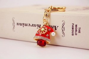 Detailed view of a crystal snowman keychain with red hat and golden metallic accents