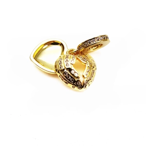 Detailed macro view of a gold-plated heart charm with zircon inlay and openable hinge