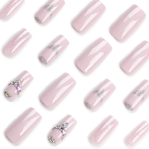 Pink press-on nail set featuring glitter gradients and sparkling rhinestone accents