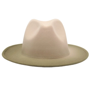 Detail view of two-tone wool fedora hat with beige crown and olive green brim
