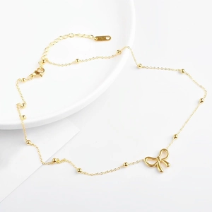 Minimalist gold titanium steel necklace featuring a hollow bow pendant and small gold beads