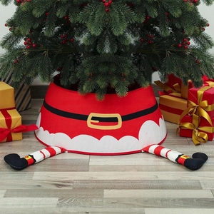 Detail of Santa Claus tree skirt with striped legs and presents under Christmas tree