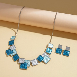 Detail of blue and white enamel geometric square pendant necklace and matching stud earrings