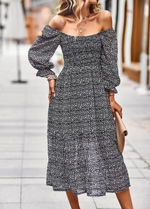 Detail of elegant black floral midi dress with puff sleeves and smocked waist design