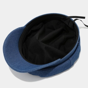 Blue denim newsboy cap with adjustable inner lining and refined vintage texture