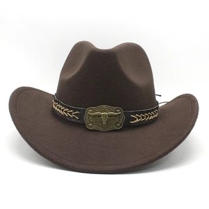 Detailed close-up of the leather band and metal longhorn buckle on a brown western cowboy hat