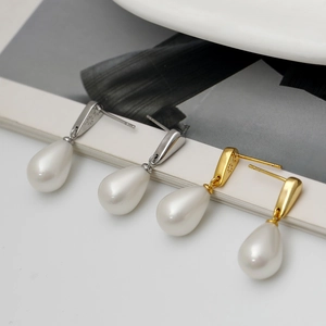Elegant teardrop pearl drop earrings in gold and silver finish shown on white background