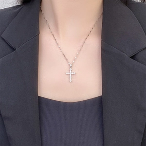 Classic silver plated cross pendant necklace with cubic zirconia worn on a neck