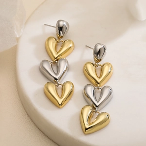Elegant gold and silver heart drop earrings with three tiered metallic heart pendants