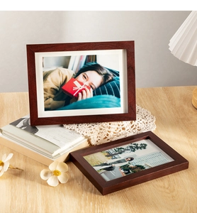 Close-up of walnut wood frames on a lace mat with warm lighting and home decor details