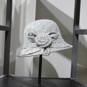 Detailed view of gray wool cloche hat featuring a delicate woven flower decoration