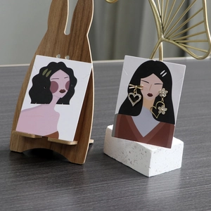 Detailed view of asymmetric heart and flower rhinestone earrings on cartoon display cards