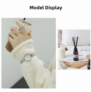 Silver quartz watch with white dial and gold ring styled with a white knit sweater