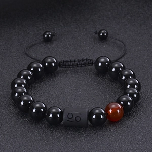 Close-up of 10mm Cancer zodiac bead bracelet with black onyx and tiger eye stones